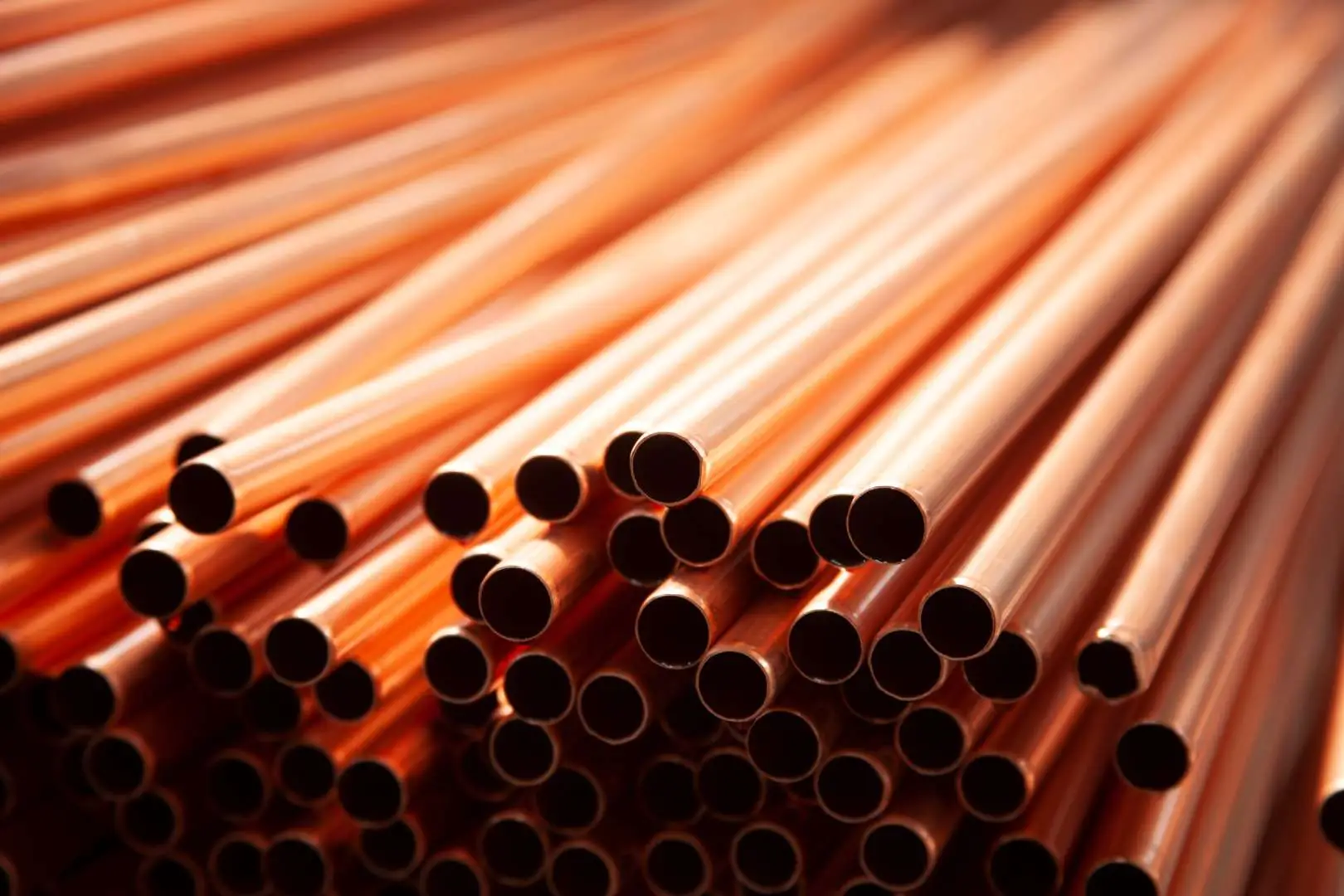 Copper pipe and tube stacked for recycling at RHK Metals Ltd Royston